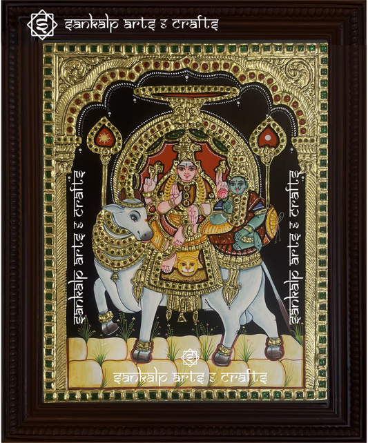 A divine Tanjore painting of Lord Shiva and Goddess Parvathi seated on Rishaba Vahanam, handcrafted with gold foil details. A perfect decor piece for homes in Chennai & Bangalore.