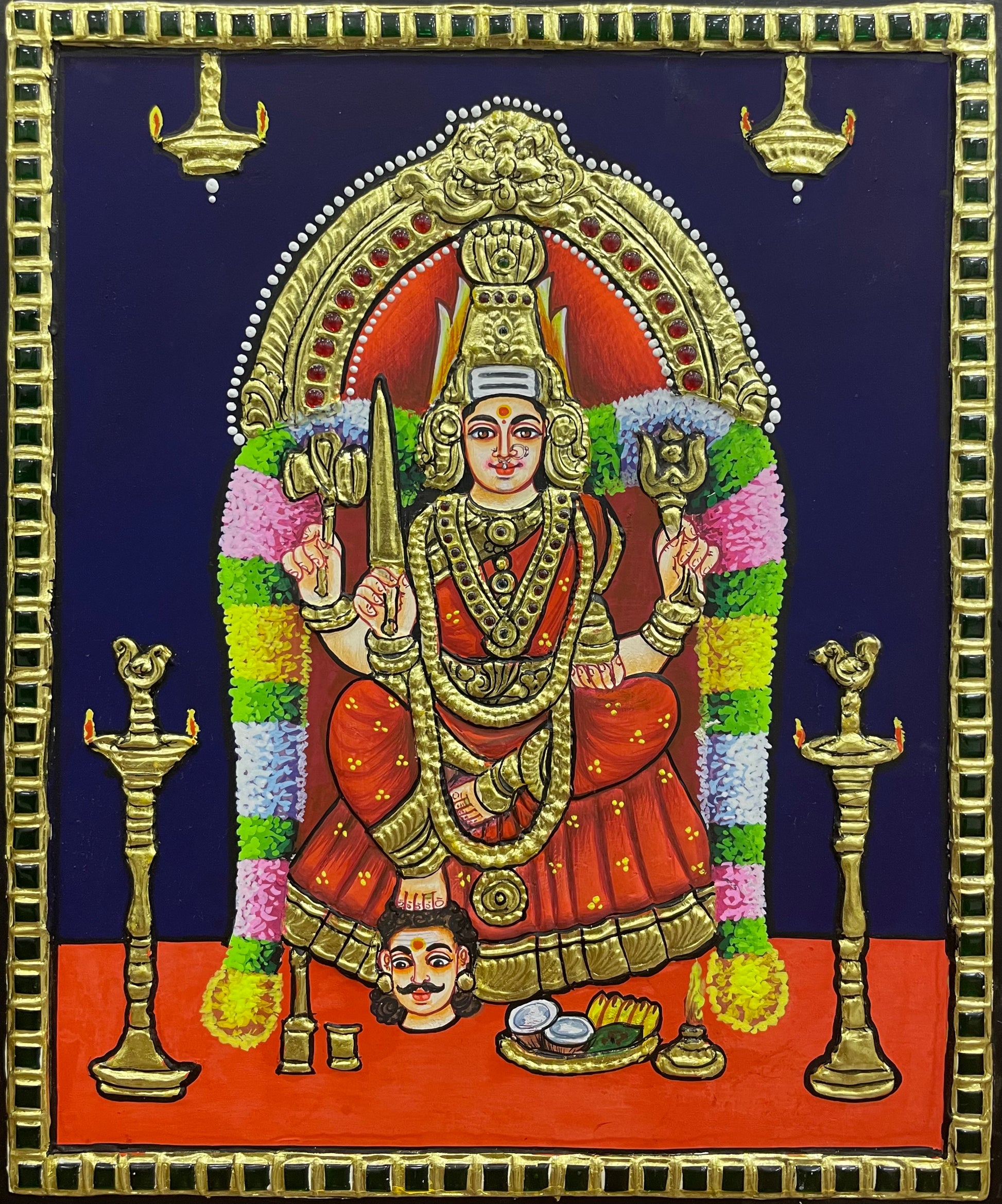 A close-up view of the Samayapuram Mari Amman Tanjore painting, showcasing the goddess’s powerful expression, rich textures, and exquisite gold embellishments.