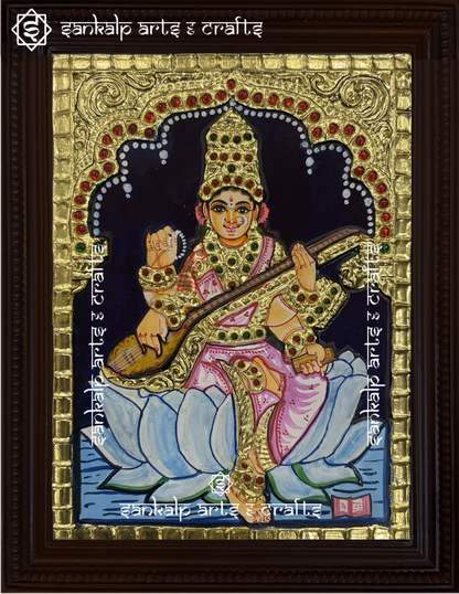 A close-up of the Saraswathi Tanjore painting showcasing Goddess Saraswathi holding her veena, with exquisite gold embellishments and rich colors, radiating divine knowledge and artistic elegance.