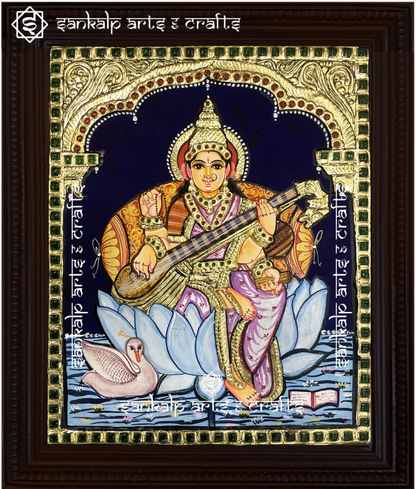 A beautifully handcrafted Saraswathi Tanjore painting depicting Goddess Saraswati, the goddess of wisdom and knowledge, adorned with intricate gold foil detailing and vibrant colors. This artwork symbolizes enlightenment, creativity, and spiritual growth.

