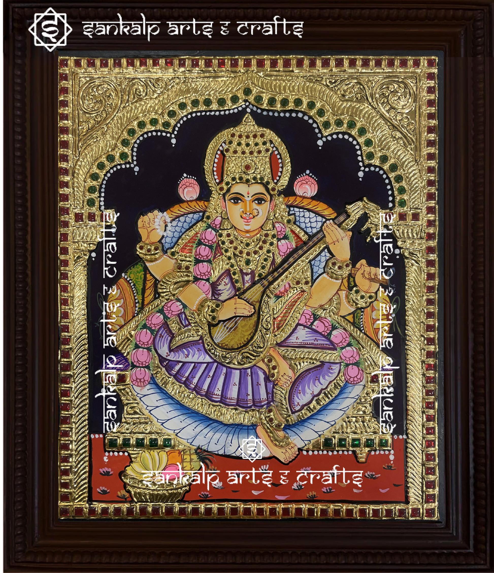 A beautifully handcrafted Saraswati Tanjore painting depicting Goddess Saraswati, the goddess of knowledge and wisdom, playing the veena. The painting is adorned with intricate gold foil detailing and vibrant colors, capturing her divine grace and wisdom.