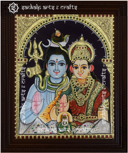 A beautifully framed Tanjore painting of Lord Shiva and Goddess Parvathi, adorned with intricate gold foil detailing. A perfect decor piece for homes in Chennai & Bangalore.

