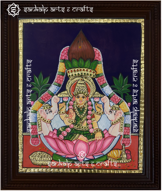 A beautifully framed Tanjore painting of Goddess Varamahalakshmi, adorned with rich gold foil work and vibrant colors. A perfect decor piece for homes in Chennai & Bangalore.